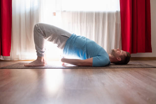 Young man doing wheel pose 